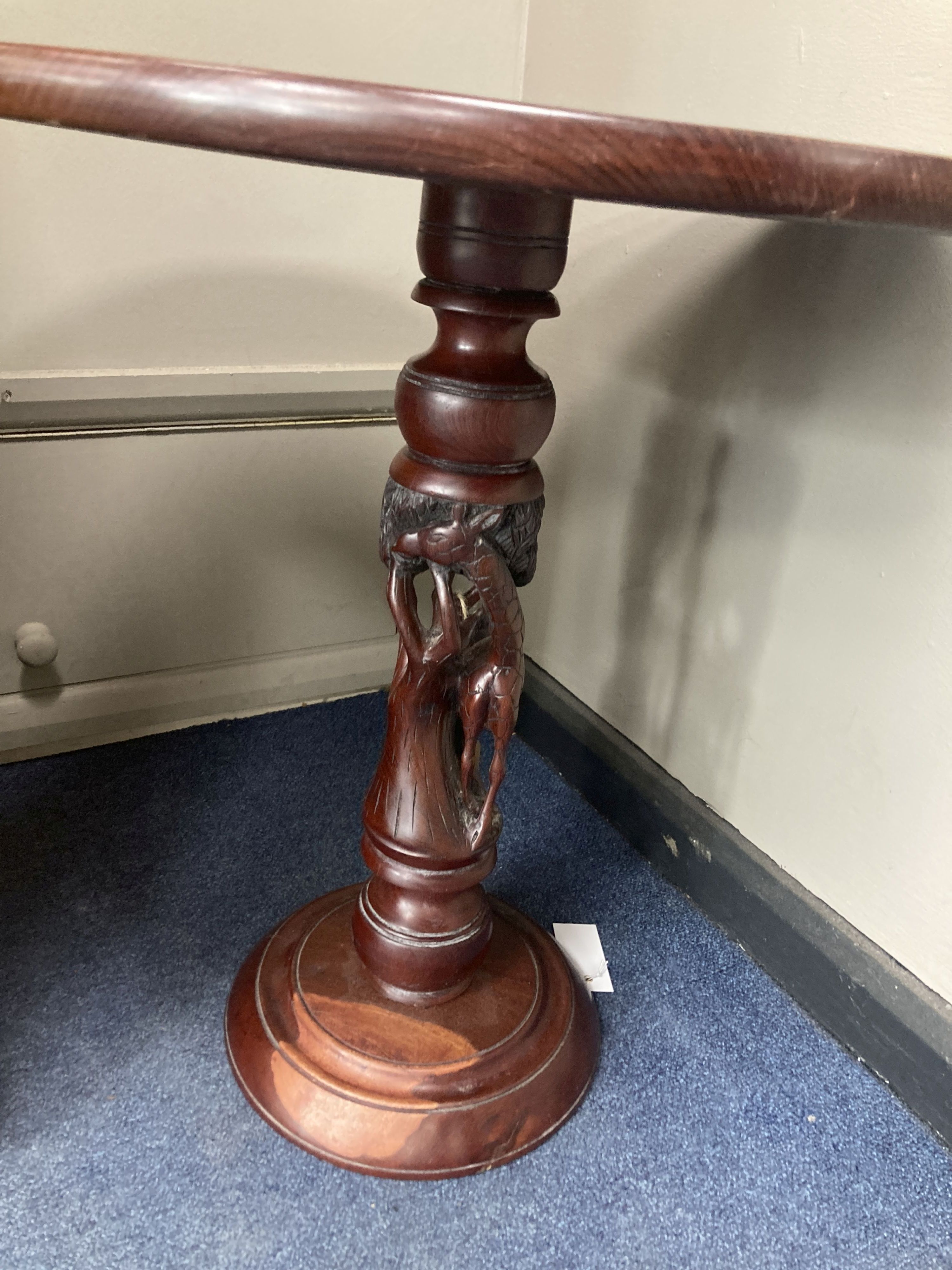 An African carved hardwood pedestal table, diameter 54cm, height 57cm